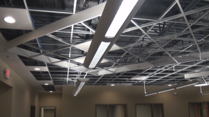 Modern suspended ceiling design using 6" Armstrong Axiom Trim on 45 degree angle